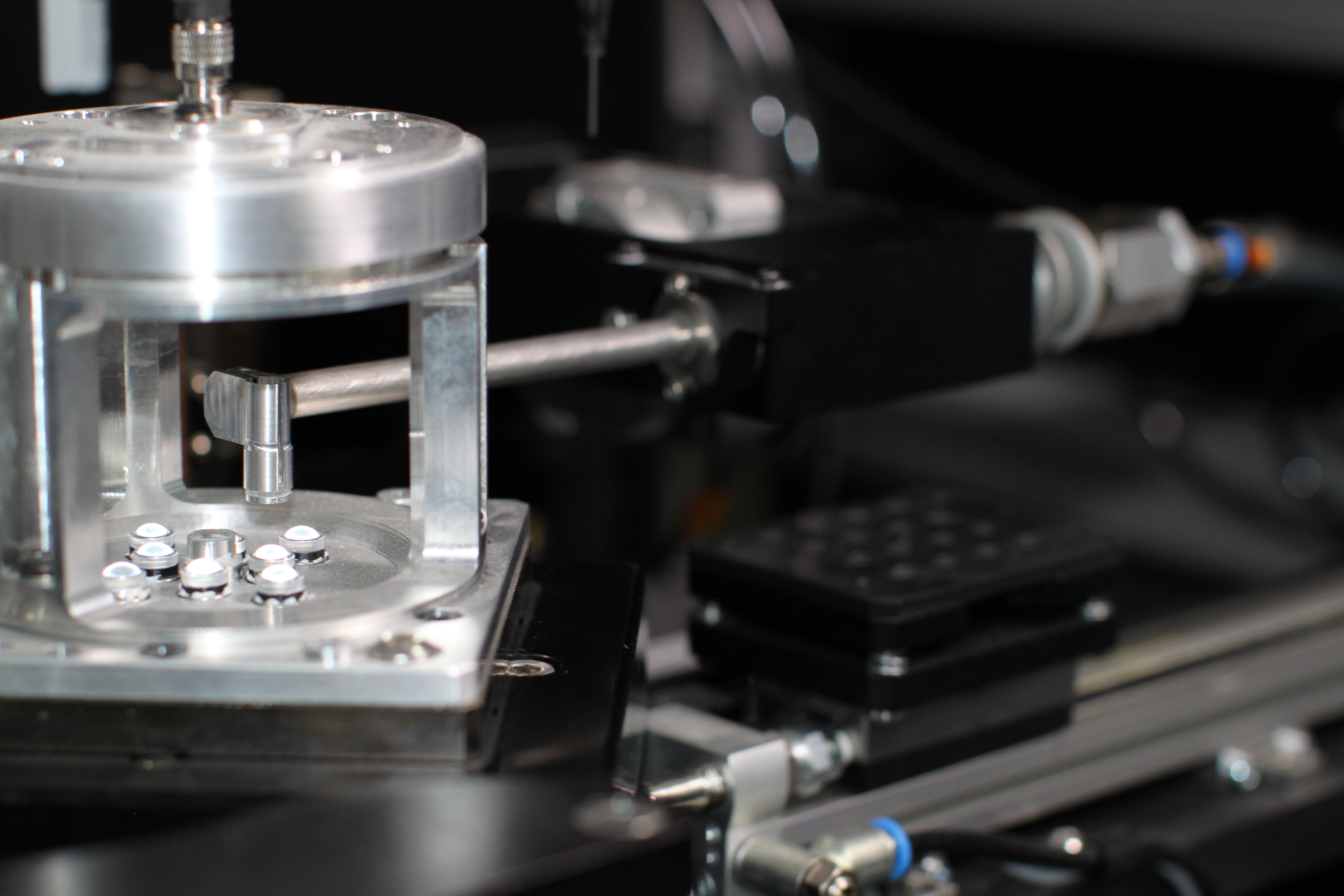 Collimating lens aligner — multi-axis optical alignment fixture
